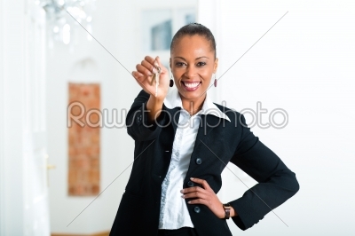 Young realtor with keys in an apartment