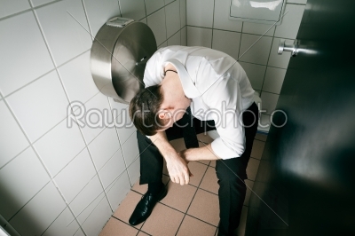Young sleeping drunk man on the toilette