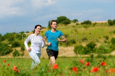 Young sportive couple is jogging outside