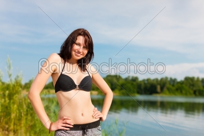 Young woman at lake in summer