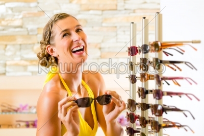 Young woman at optician shopping sunglasses