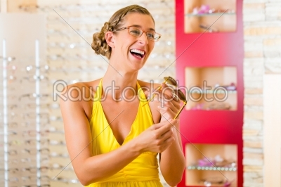 Young woman at optician with glasses