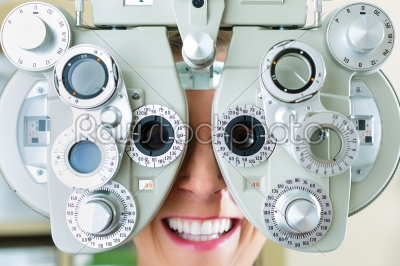 Young woman at phoropter for eye test