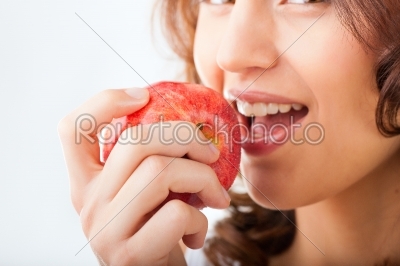 Young woman bites in a apple