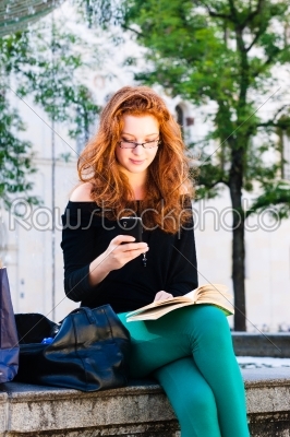 Young Woman calls with mobile phone in Park