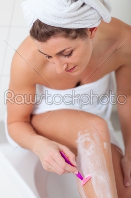 Young woman doing Hair removal at legs