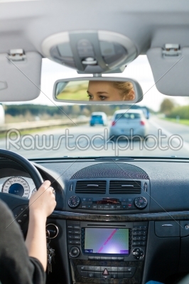 Young woman driving by car on motorway