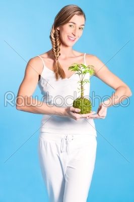 Young Woman holding a small tree