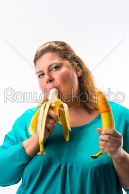 Young woman holding banana with condom 