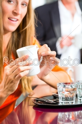 Young woman holding cup of coffee in hand