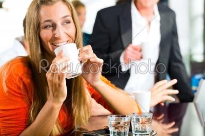 Young woman holding cup of coffee in hand
