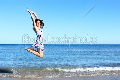 Young woman jumping on a beach