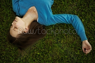 Young woman lying in the grass