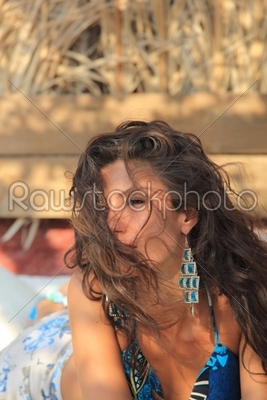 Young woman relaxing at summer lounge 