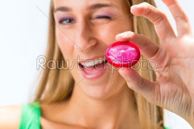 Young woman with a condom