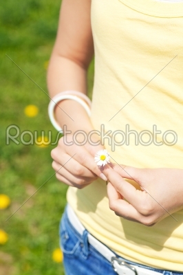 Young woman with daisy