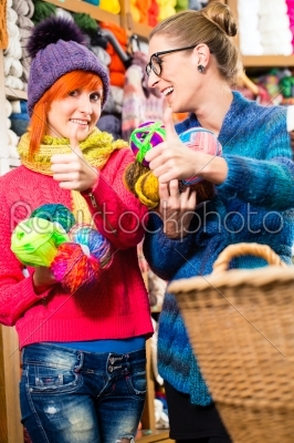 Young women in knitting fashion shop