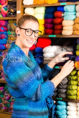 Young women in knitting shop