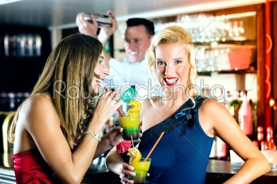 Young women with cocktails in club or Bar