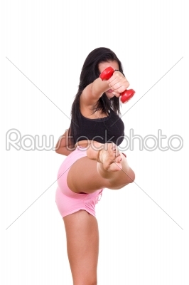 active woman with weights giving a kick with a leg