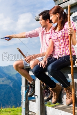 Alps - Man and woman sitting at cabin in tirol