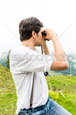 Alps - Man on mountains with field glasses 