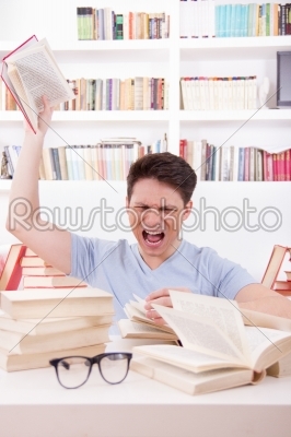 angry student  surrounded by books  throws a book