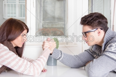arm wrestling challenge between a young couple