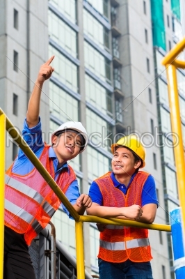 Asian architect and supervisor on construction site