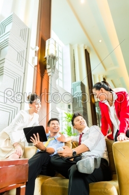 Asian Chinese business people meeting in hotel lobby