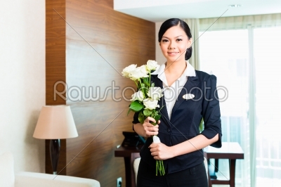 Asian Chinese hotel manager welcomes arriving VIP guests 