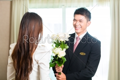 Asian Chinese hotel manager welcoming VIP guest