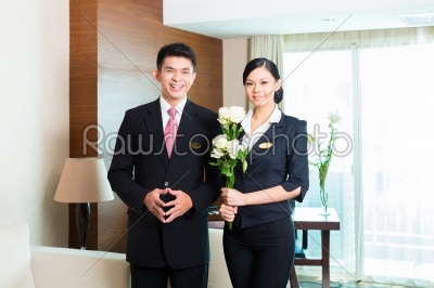 Asian Chinese hotel manager welcoming VIP guests