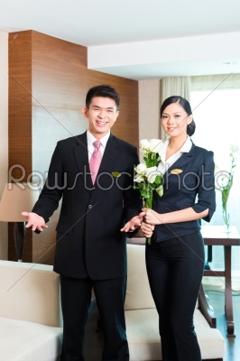 Asian Chinese hotel manager welcoming VIP guests