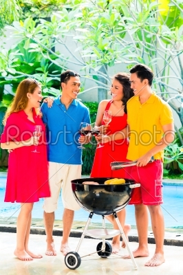 Asian couples having barbecue and drinking wine
