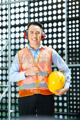 Asian Indonesian construction worker on building site