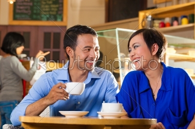 Asian woman and man in an coffee shop