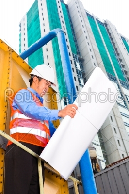 Asian worker or supervisor on building site 