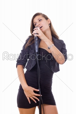 beautiful young woman singing on microphone in black dress