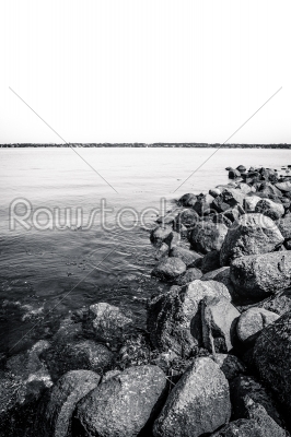 Black and white ocean landscape with rocks