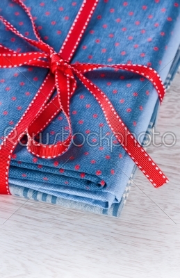 Blue fabric pile with red ribbon