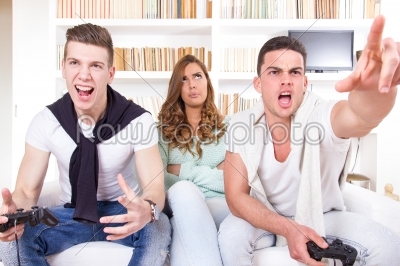 bored women between two casual passionate men playing video game