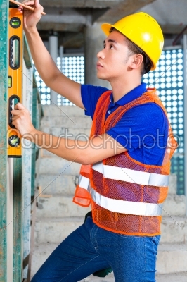 Builder or worker controlling building or construction site