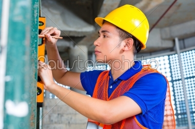 Builder or worker controlling building or construction site