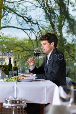 Businessman has lunch in restaurant
