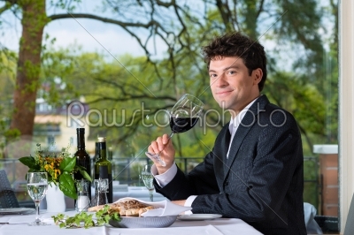 Businessman has lunch in restaurant