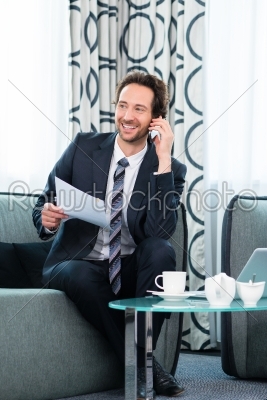 businessman in business hotel is on the phone