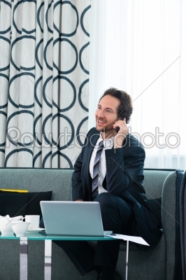 businessman in hotel is on the phone