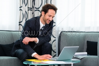 businessman in hotel working on laptop