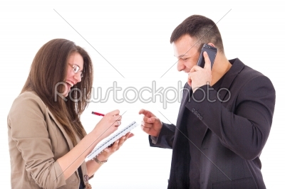 businessman on the phone and his secretary writing down notes